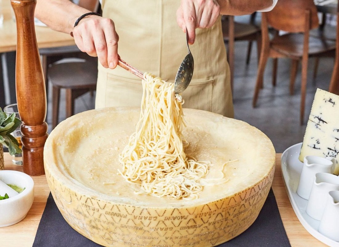 Pasta finished in a wheel of Grana Padano
